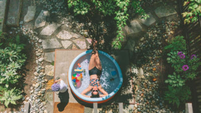 Woman and son in backyard pool